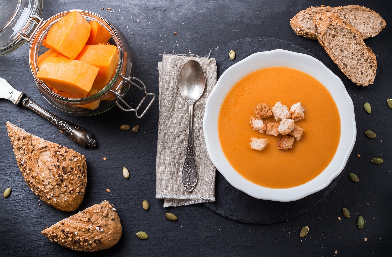 Pumpkin soup in a white bowl on table
